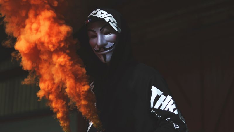 Guy Fawkes mask, Man in Mask, Black Hoodie, Orange Smoke, Dark background, Anonymous, 5K, Wallpaper