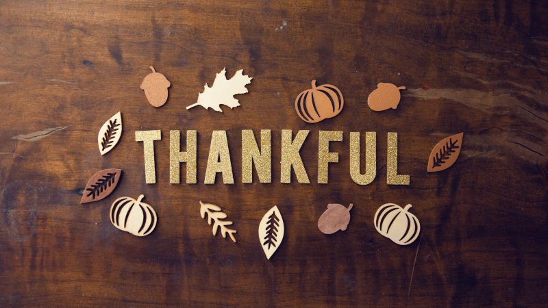 Thanksgiving day thankful wooden background glitter letters 