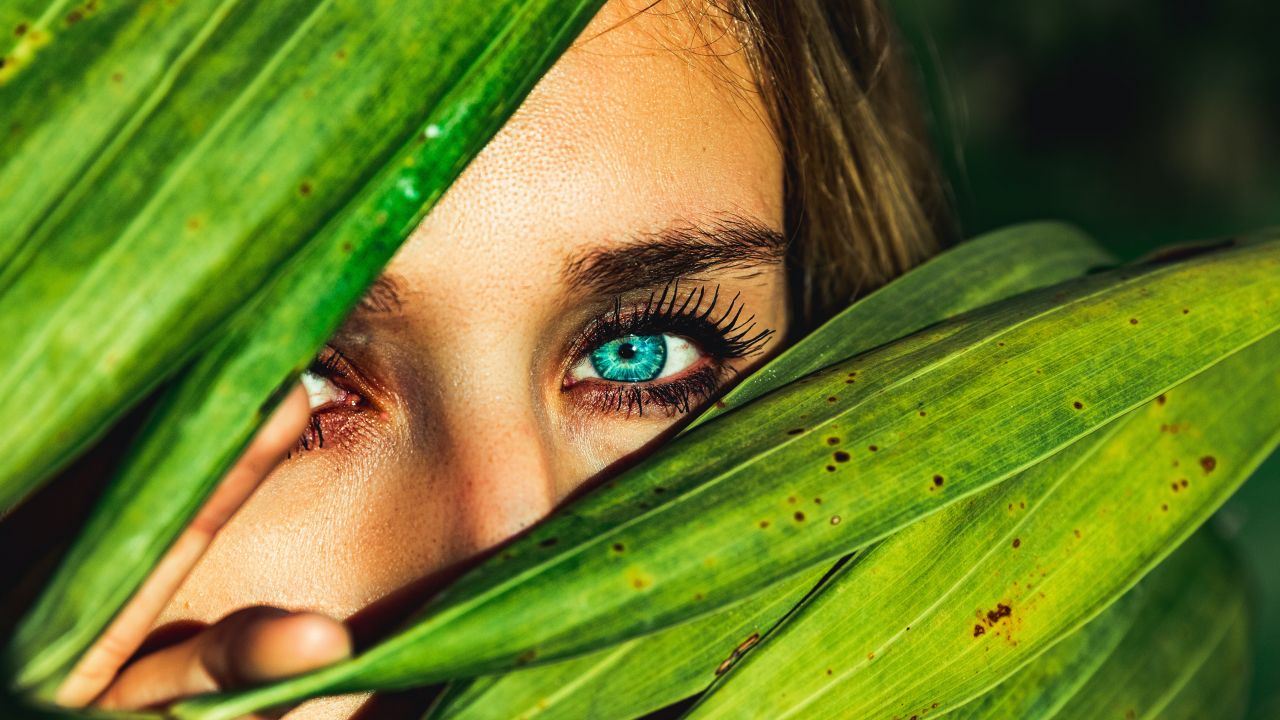blue eyes green leaves woman face macro peek 5k